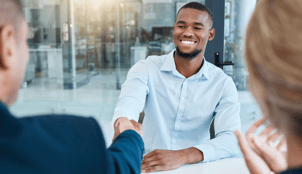 man shaking hands with an interviewer 