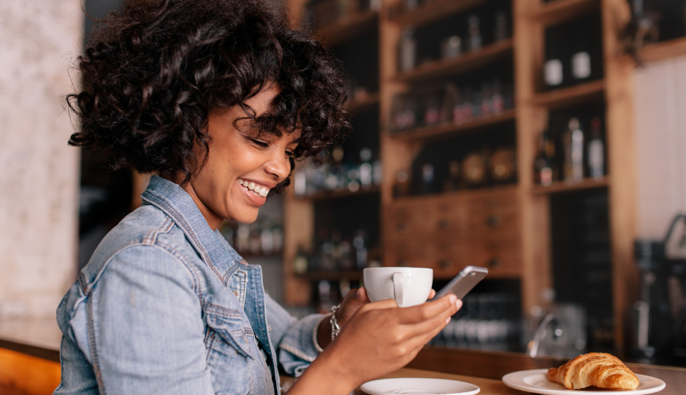 Woman smiling and looking at her phone