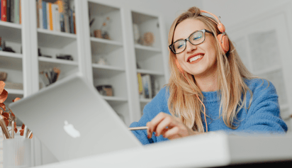 woman wearing glasses working on her budget on her laptop