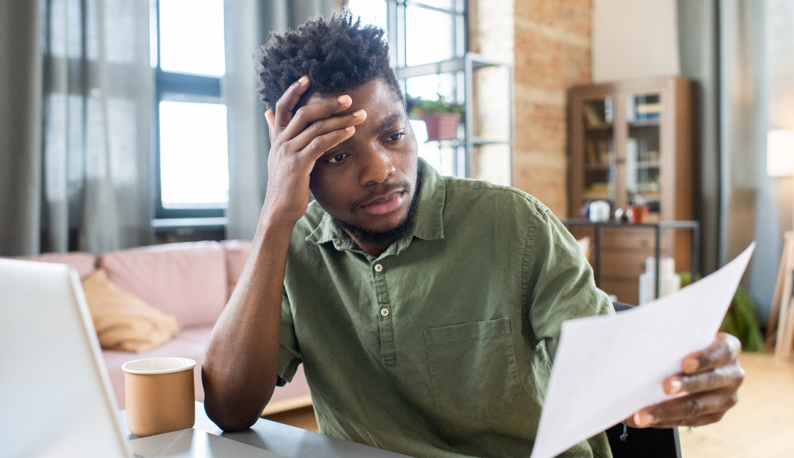 man looking at his bill stressed